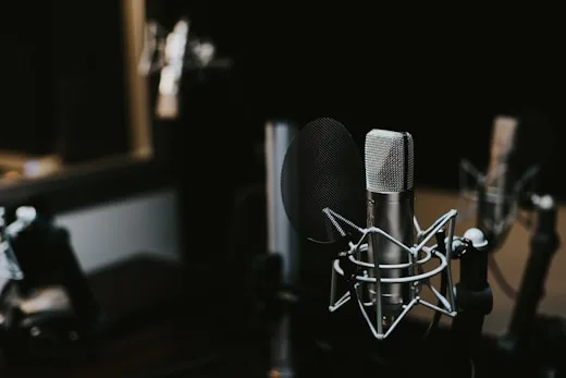Studio Microphone | CAQA Creative A studio condenser microphone with a pop filter is shown, ideal for music production.